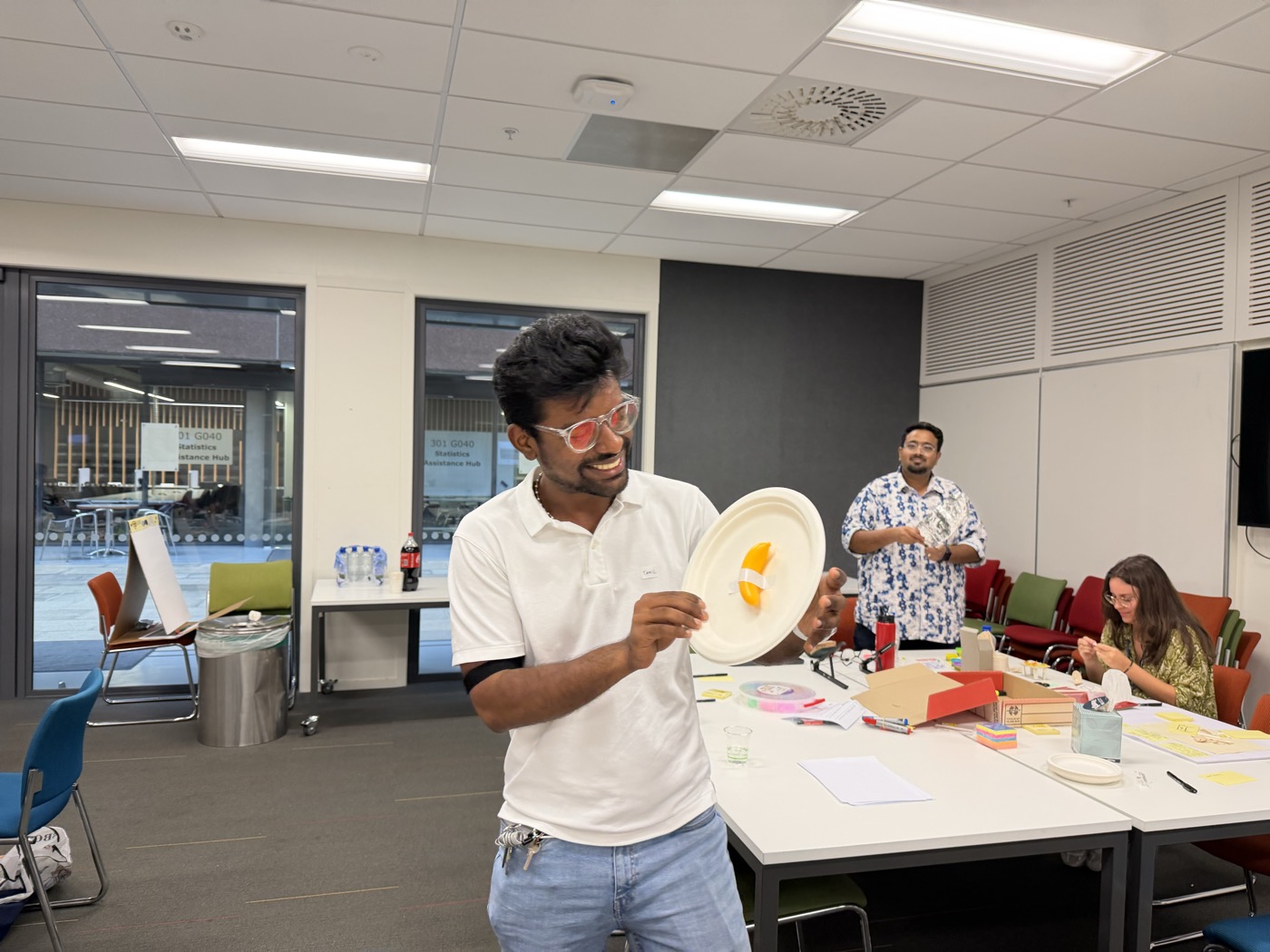 Tamil presenting a paper plate prototype to the group